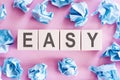 The word easy on white cubes on a pink background Royalty Free Stock Photo