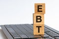 Word EBT made with wood building blocks on the keyboard, stock image Royalty Free Stock Photo