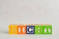 The word eight (8) spelled with colorful alphabet blocks