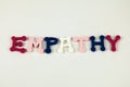 The word Empathy formed with colorful felt letters