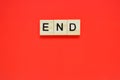 Word end. Top view of wooden blocks with letters on red surface