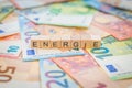 The word Energie - in German for Energy - written on banknotes Euro notes with wooden cube Royalty Free Stock Photo