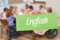 English against pretty teacher helping pupils in classroom Royalty Free Stock Photo