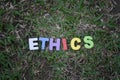 Word ethics on grass with vignette effect Royalty Free Stock Photo