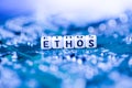 Word ETHOS formed by alphabet blocks on mother cryptocurrency