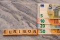 Word EURIBOR Is Written In Wooden Letters, Near Part Of 5, 10, 20 and 50 Euro Banknotes. High quality photo