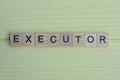 the word executor of gray small wooden letters