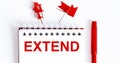 The word EXTEND is written in the notebook with office tools Royalty Free Stock Photo
