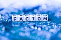 Word FACTOM formed by alphabet blocks on mother cryptocurrency Royalty Free Stock Photo