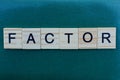 Word factor made from wooden gray letters