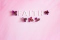 The word, FAITH, spelled in capital letters written horizontally with hydrangea flowers