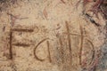 Faith written in sand, background Royalty Free Stock Photo