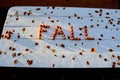 Word FALL made of crab apples on white wooden table Royalty Free Stock Photo