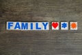 Word family from volumetric colored letters on a dark wooden background, concept of marriage, weddings, honeymoon time, content