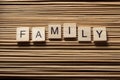 Word FAMILY written on wooden cubes at wooden background