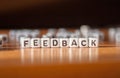 The word FEEDBACK made of white plastic blocks on the table Royalty Free Stock Photo