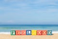 Word FEELGOOD in colorful alphabet blocks on tropical beach Royalty Free Stock Photo