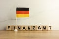 Word finanzamt which means tax office in German and flag of Germany Royalty Free Stock Photo