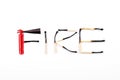 Word fire made of burnt matches and a tiny fire extinguisher Royalty Free Stock Photo