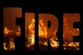 The word FIRE filled in with extreme close up of a wild grass fire in landscape format on black background. Royalty Free Stock Photo