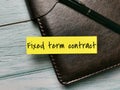 Word fixed term contract written on sticky note with a pen. Royalty Free Stock Photo