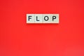 Word flop. Top view of wooden blocks with letters on red surface Royalty Free Stock Photo
