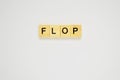 Word flop. Top view of wooden blocks with letters on white surface Royalty Free Stock Photo