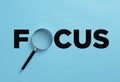 The word focus with magnifier. Concentration in business and education concept Royalty Free Stock Photo