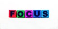 The word FOCUS is written on colorful cubes on a light background Royalty Free Stock Photo