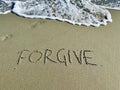 Word forgive in the sand Royalty Free Stock Photo