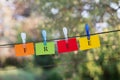 Word Free spelled on colorful papers hanging on a rope attached by clothes peg Royalty Free Stock Photo
