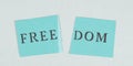 The word freedom is staning on a torn apart paper, new normal, covid-19 regulations, changing life