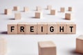 The word freight on wooden cube. Logistic distribution, warehouse or delivery industry or business concept