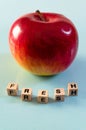 The word fresh written in cubes and an apple Royalty Free Stock Photo