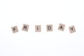 Word friday arranged from wooden blocks on white background. Game