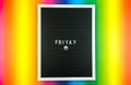 The word FRIDAY on a letter board with happy smiley emoji against multicolor background