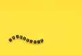 The word friendship composed from cubes with multicolored letters on a yellow background.Wave shape