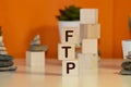 The Word FTP Formed By Wooden Blocks On A White Table