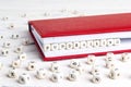 Word Fundraising written in wooden blocks in red notebook on white wooden table.