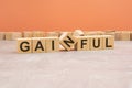 word GAINFUL made with wood blocks. orange background Royalty Free Stock Photo