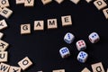 Word GAME with wooden letters on black Board with dice and letter in the circle Royalty Free Stock Photo