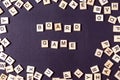 Word GAME with wooden letters on black Board with dice and letter in the circle Royalty Free Stock Photo