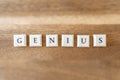 The word Genius on a wooden background. Royalty Free Stock Photo