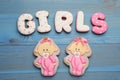 Word Girls made of tasty cookies on light blue wooden table, flat lay. Baby shower party