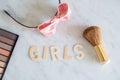 Word GIRLS with wooden letters and make up accessories. Concept of female identity