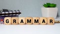 the word grammar wooden cubes with burnt letters, study of grammar of different languages, gray background.