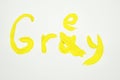 The word gray with the letter a crossed out is written in yellow paint. Bug fix