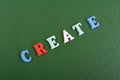 CREATE word on green background composed from colorful abc alphabet block wooden letters, copy space for ad text. Learning english