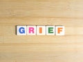 Word Grief on wood background