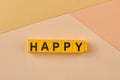 The word HAPPY written on yellow cubes close up. Royalty Free Stock Photo